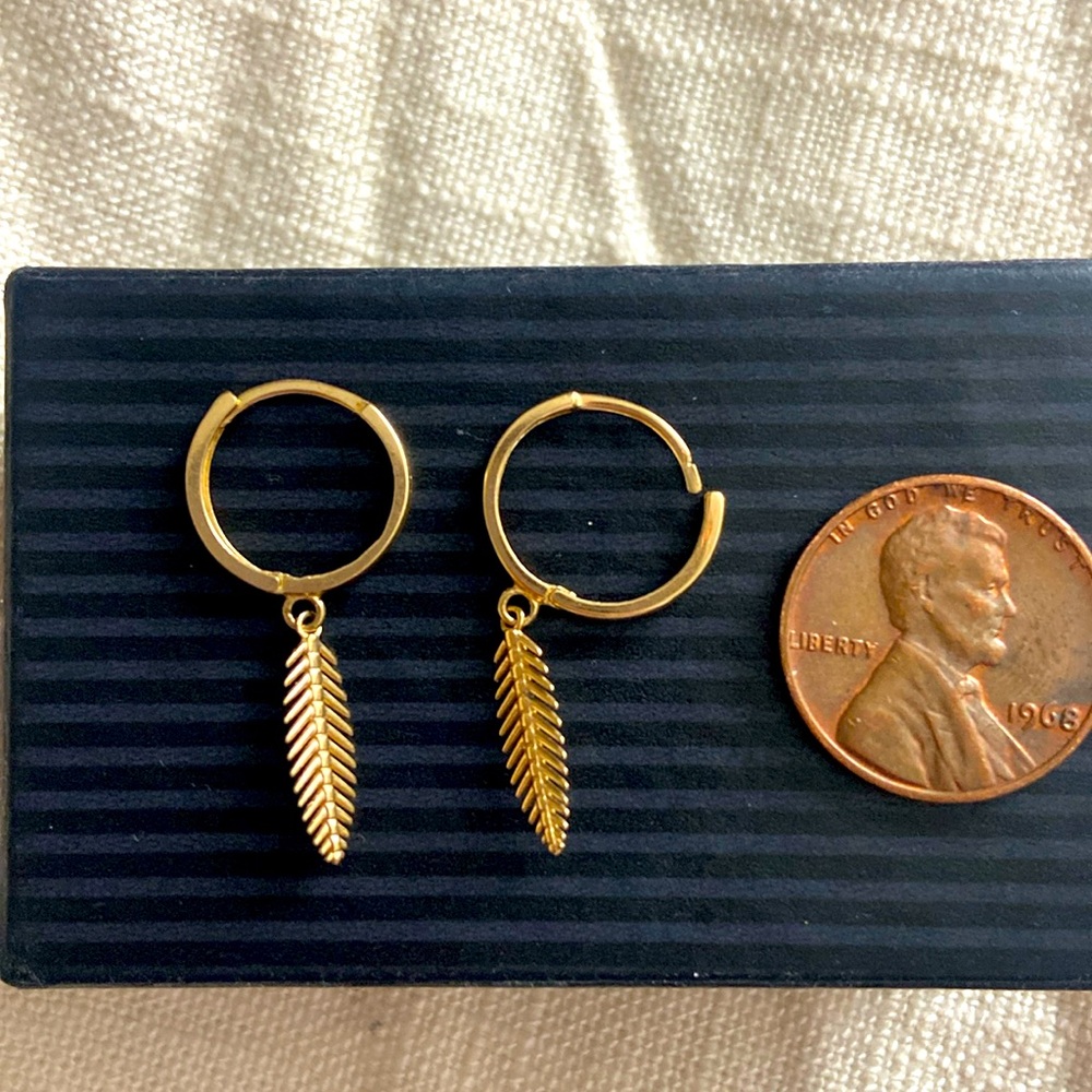 10k gold hinged hoop earrings with leaf dangle.